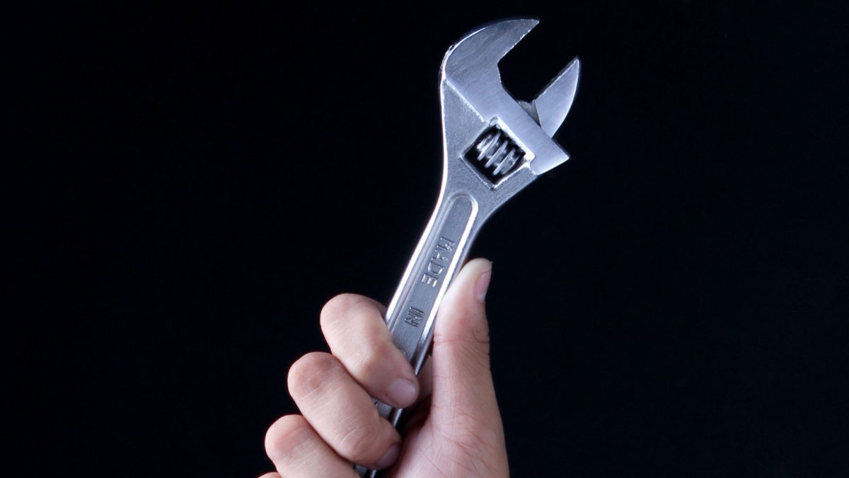 hand holding wrench